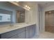 Double vanity bathroom with gray cabinets and marble flooring at 2711 Dolce Rd, Dacula, GA 30019