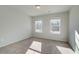 Bright bedroom with carpet flooring and two large windows at 867 Eagle Avenue, Riverdale, GA 30247