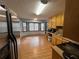 An open kitchen features wood cabinets, stainless steel appliances, and a light-filled eating nook at 5585 Pennybrook Ct, Stone Mountain, GA 30087