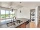 Contemporary kitchen island with stainless steel sink, dishwasher, and washer/dryer, showcasing functionality and modern living at 563 Memorial Se Dr # 503, Atlanta, GA 30312