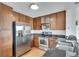 Well-equipped kitchen featuring stainless steel appliances, wood cabinets, granite countertops, and hardwood floors at 563 Memorial Se Dr # 503, Atlanta, GA 30312