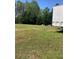 Spacious grassy lot with a storage container and mature trees at 1565 Dr Bramblett Rd, Cumming, GA 30028