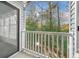 View from balcony shows white railing with wooded and sunny view at 1115 Cannongate Sw Xing, Marietta, GA 30064