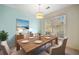 Bright dining room with hardwood table and chairs, light fixture, and large window at 1115 Cannongate Sw Xing, Marietta, GA 30064