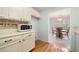 Kitchen view of microwave, laminate countertop, and view of eat-in kitchen at 1115 Cannongate Sw Xing, Marietta, GA 30064