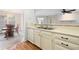 Kitchen overlooking dining area features white cabinets, laminate counters, and stainless steel sink at 1115 Cannongate Sw Xing, Marietta, GA 30064