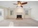 Spacious living room featuring a fireplace, fan, and bright, airy windows at 1115 Cannongate Sw Xing, Marietta, GA 30064