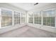 A bright sunroom with many large windows and plush carpeting at 1115 Cannongate Sw Xing, Marietta, GA 30064