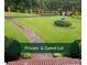 Private gated lot with a well-manicured lawn, walkway, landscaping and mature trees at 3368 Ashford Dunwoody Rd, Atlanta, GA 30319