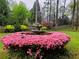 Lush front yard featuring a fountain surrounded by pink azaleas and mature trees at 3368 Ashford Dunwoody Rd, Atlanta, GA 30319