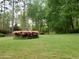 A lush front yard featuring a stone fountain surrounded by pink azaleas and mature trees at 3368 Ashford Dunwoody Rd, Atlanta, GA 30319