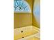 This bathroom boasts an soaking tub with a picturesque stained-glass window above at 321 Bouldercrest Way, Woodstock, GA 30188