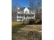 Two story home with a wraparound porch and a two car detached garage at 321 Bouldercrest Way, Woodstock, GA 30188
