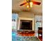 Fireplace between two windows with floral curtains and hardwood floors at 321 Bouldercrest Way, Woodstock, GA 30188