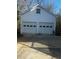 Detached two-car garage featuring white doors and siding at 321 Bouldercrest Way, Woodstock, GA 30188