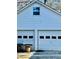 Two-car garage with white doors and siding at 321 Bouldercrest Way, Woodstock, GA 30188