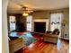 Comfortable living room featuring hardwood floors, ceiling fan, and a stone fireplace at 321 Bouldercrest Way, Woodstock, GA 30188