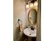 Powder room with pedestal sink, round mirror, and decorative lighting at 321 Bouldercrest Way, Woodstock, GA 30188