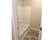 Bathroom featuring a shower and tub combination with gray wood-look flooring at 1255 Silverstone Trl, Jonesboro, GA 30238