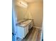 Bathroom featuring a double vanity with granite countertop and stylish lighting at 1255 Silverstone Trl, Jonesboro, GA 30238