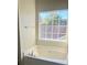 Bathroom featuring a large soaking tub with view from bright window at 1255 Silverstone Trl, Jonesboro, GA 30238