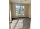Bright bedroom featuring a neutral color palette, plush carpet, and a large window offering natural light at 1255 Silverstone Trl, Jonesboro, GA 30238
