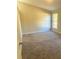 Bedroom with neutral walls and carpet has a sunny window at 1255 Silverstone Trl, Jonesboro, GA 30238