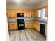Functional kitchen with wood cabinets, granite countertops, and modern appliances at 1255 Silverstone Trl, Jonesboro, GA 30238