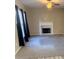 Cozy living room with a fireplace, neutral carpet, and natural light at 1255 Silverstone Trl, Jonesboro, GA 30238