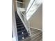 Carpeted stairs and open foyer with wood railing lead to the upper level at 1255 Silverstone Trl, Jonesboro, GA 30238
