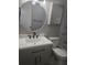 Modern bathroom with gray vanity and frameless mirror at 4129 Pepperdine Dr, Decatur, GA 30034