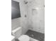 Shower with marble-style tile and pebble floor at 4129 Pepperdine Dr, Decatur, GA 30034