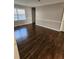 Dining room with dark hardwood floors and view of kitchen at 4129 Pepperdine Dr, Decatur, GA 30034