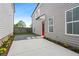 Inviting backyard with a concrete patio, gravel accents, and a red door on a gray home exterior at 40 Spirea Way, Auburn, GA 30011