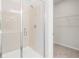 Glass-enclosed shower with tile surround, and an adjacent walk-in closet at 40 Spirea Way, Auburn, GA 30011