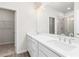 Bathroom featuring double sinks, a large mirror, and access to a closet and shower at 40 Spirea Way, Auburn, GA 30011