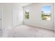 Spacious bedroom with two windows offering natural light and a closet, freshly carpeted at 40 Spirea Way, Auburn, GA 30011