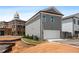 Gray two-story home featuring a two car garage and manicured front yard at 40 Spirea Way, Auburn, GA 30011