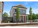 A charming two-story home with gray siding, white trim, a front porch and a bright red front door at 40 Spirea Way, Auburn, GA 30011