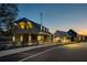 Inviting exterior showcasing multiple modern farmhouse buildings with a well-lit parking area at 40 Spirea Way, Auburn, GA 30011