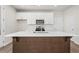 Modern kitchen showcases a large island with white countertops and dark wood base, ideal for entertaining at 40 Spirea Way, Auburn, GA 30011