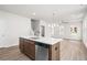 Open concept kitchen with stainless steel appliances, a kitchen island, and hardwood floors at 40 Spirea Way, Auburn, GA 30011