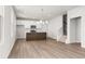 Open-concept living and kitchen area with hardwood floors and a staircase at 40 Spirea Way, Auburn, GA 30011