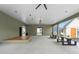 Wide patio space featuring concrete flooring, a wood stage, picnic tables, and a ceiling fan for outdoor relaxation at 40 Spirea Way, Auburn, GA 30011