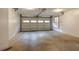 Spacious garage with concrete floor and automatic garage door at 1800 E Gate Dr, Smoke Rise, GA 30087