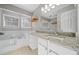 Bathroom features granite countertop, a large soaking tub, and tile flooring at 1238 Sandy Creek Rd, Fayetteville, GA 30214