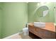 Modern bathroom with green walls and updated vanity at 1238 Sandy Creek Rd, Fayetteville, GA 30214