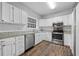 Updated kitchen with stainless steel appliances and white cabinets at 1238 Sandy Creek Rd, Fayetteville, GA 30214