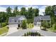 Aerial view of two houses on a tree-lined street at 1005 Coleman Place Dr, Roswell, GA 30075