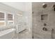 Modern bathroom with a soaking tub, shower, and white vanity at 1005 Coleman Place Dr, Roswell, GA 30075